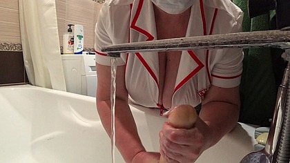 Big tits under a medical gown. A work camera watches a mature nurse in the bathroom.