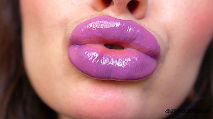 Wet violet glossy kiss close up