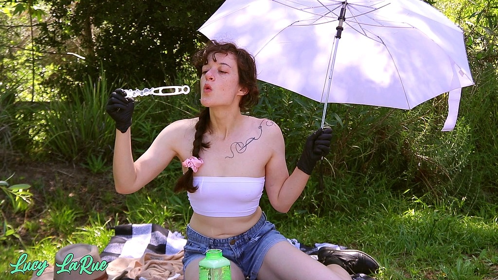 blowing bubbles outside in a bandeau and nitrile gloves (Lucy LaRue) blowing bubbles outside in a bandeau and nitrile gloves (Lucy LaRue)