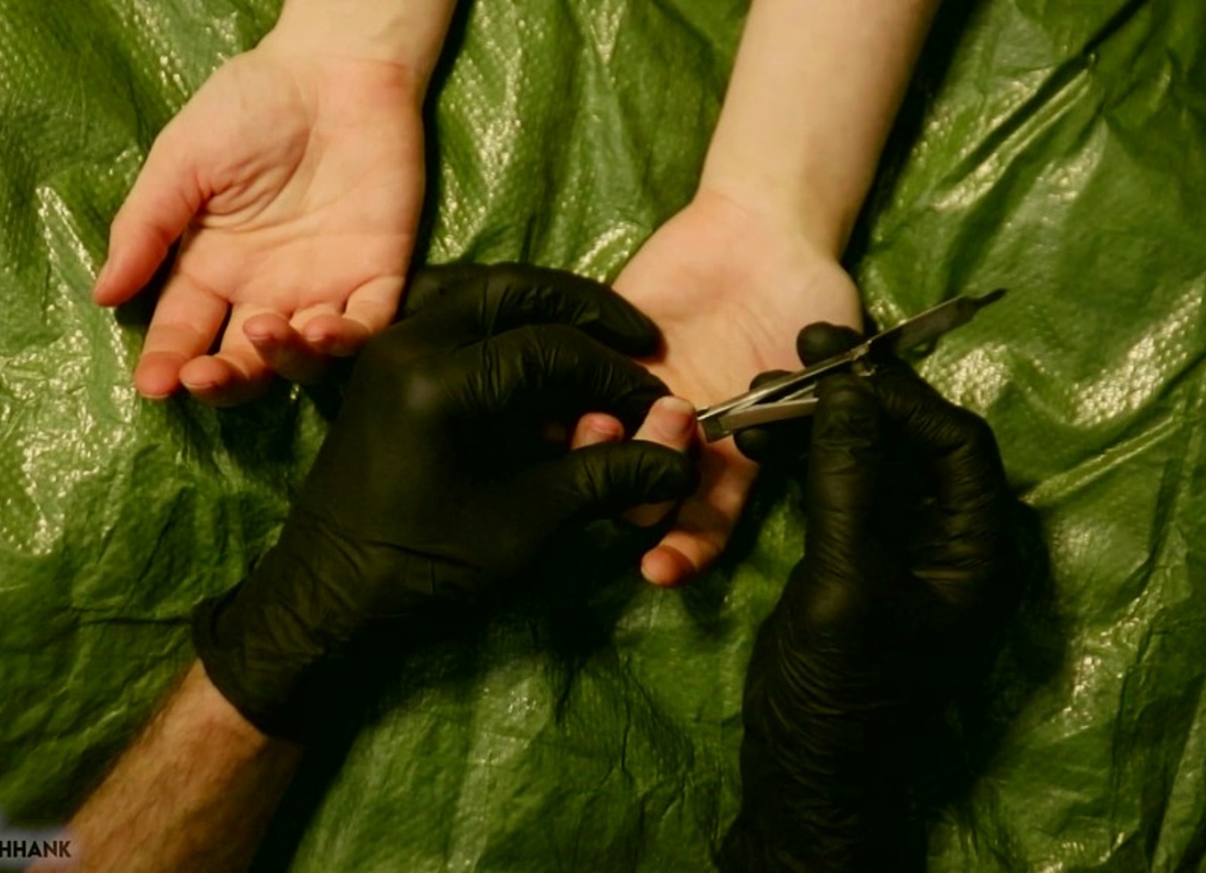 Tarp And Black Nitrile Gloves Fingernail Clipping