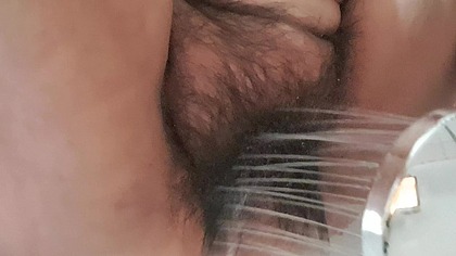 Milf dripping water on her hairy vagina