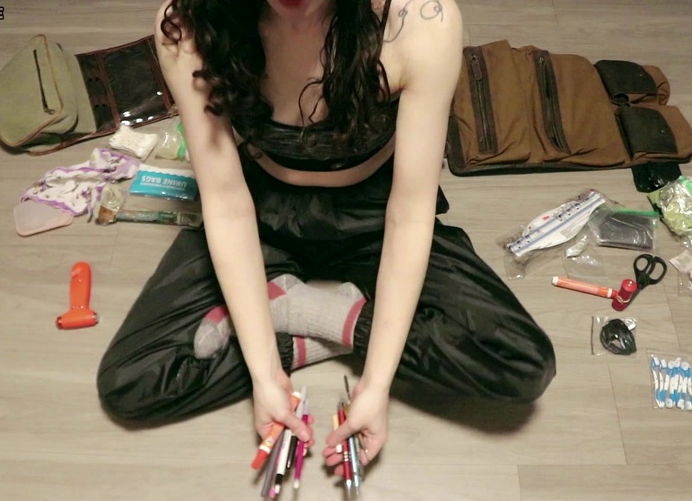 Organizing Travel Bags In Sports Bra And Windbreaker Pants