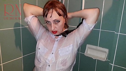 A chick in clothes under the shower. Wet panties, wet trousers, wet shirt.