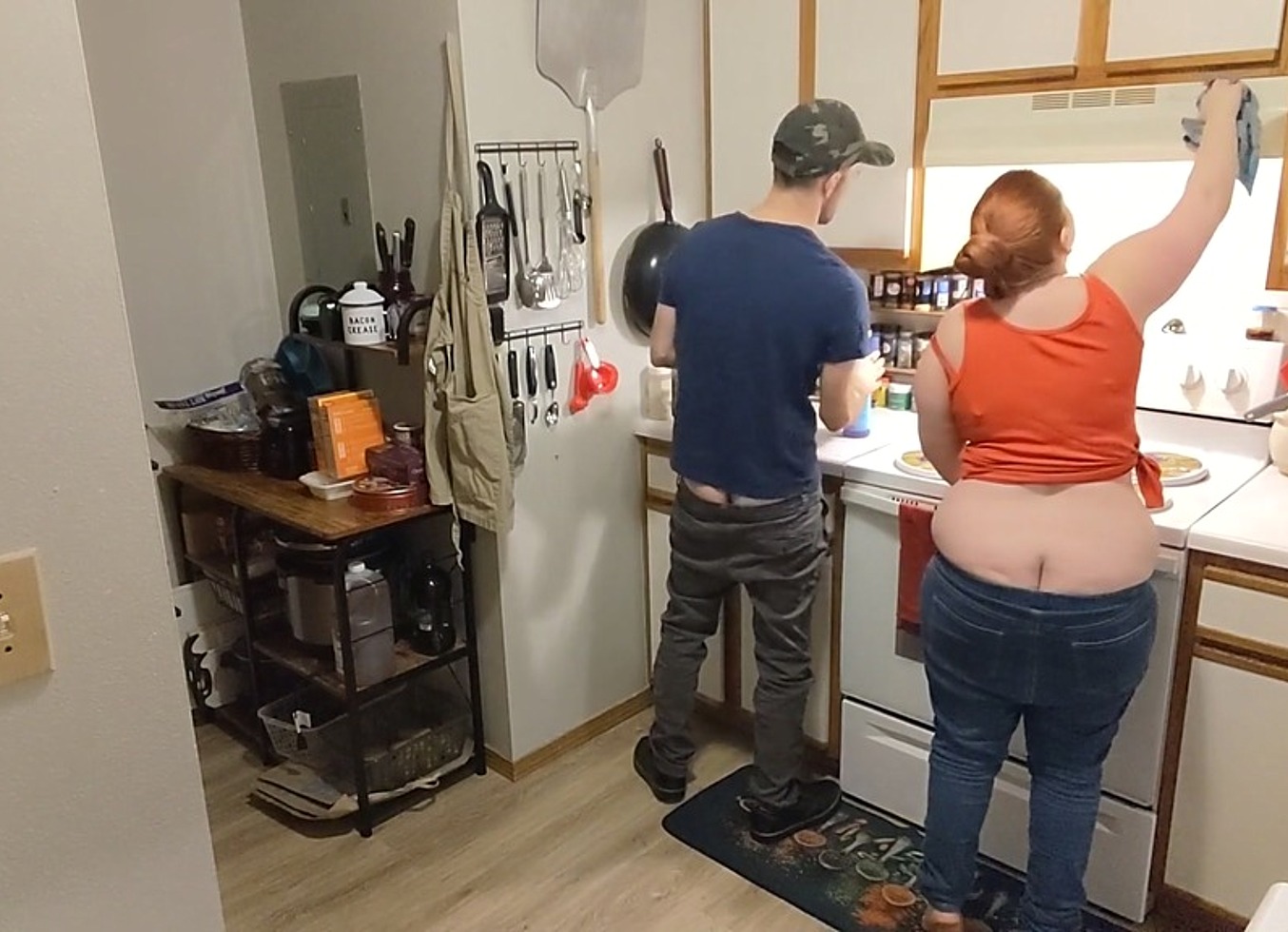 Couple's Buttcracks Exposed Cleaning Kitchen Cabinets